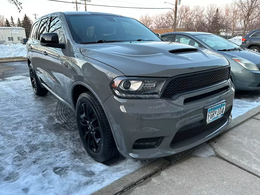 A freshly painted and fixed grey car, exhibiting a rejuvenated appearance after maintenance or repairs, showcasing precision and care in the restoration process.