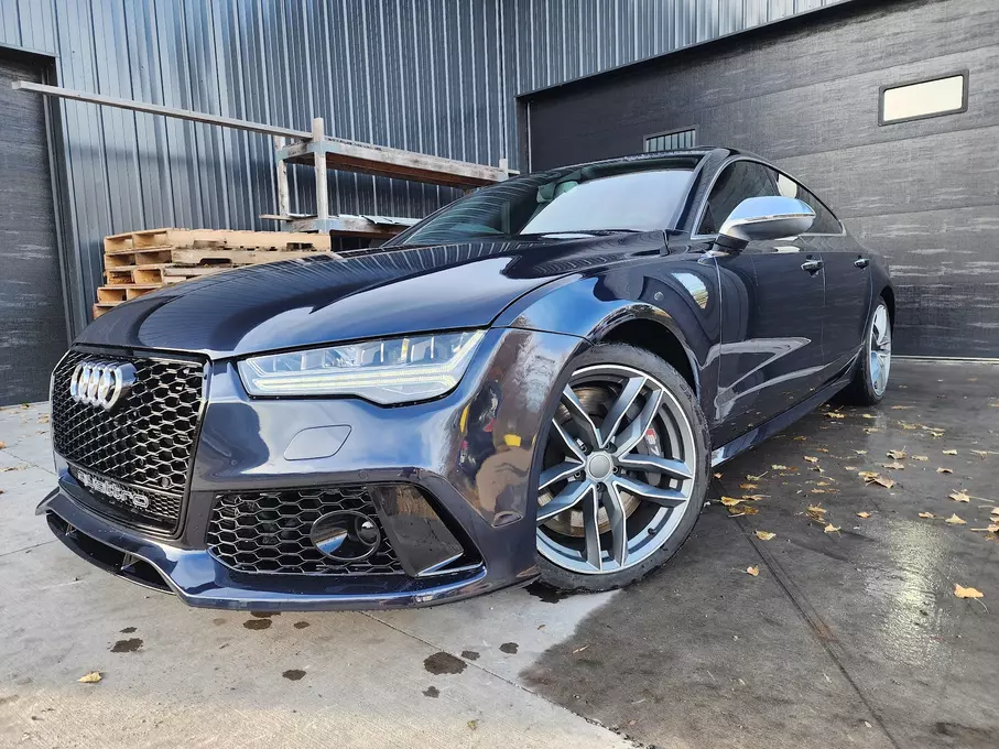 A freshly painted and fixed black car, displaying a sleek and revitalized appearance after maintenance or repairs, highlighting the attention to detail in the restoration process.