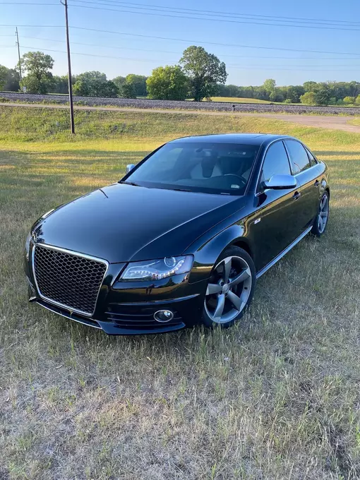 A freshly painted and fixed black car, displaying a sleek and revitalized appearance after maintenance or repairs, highlighting the attention to detail in the restoration process.