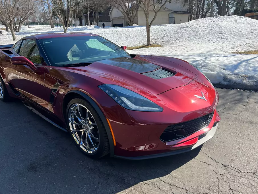 A freshly painted and fixed red car, radiating a renewed and vibrant appearance after maintenance or repairs, showcasing attention to detail in the restoration process.