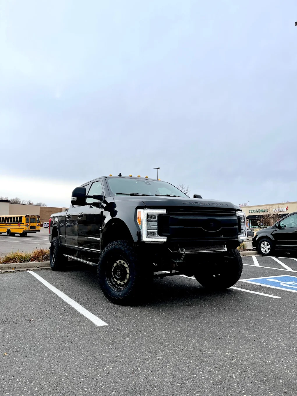 A freshly painted and fixed black car, displaying a sleek and revitalized appearance after maintenance or repairs, highlighting the attention to detail in the restoration process.