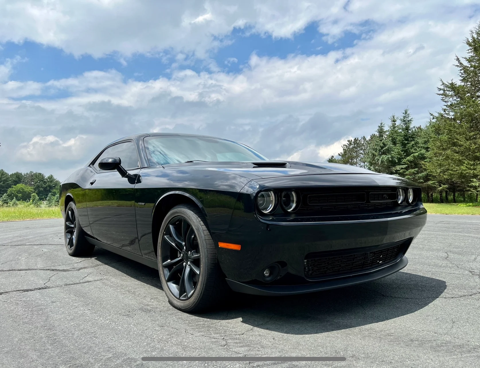 A freshly painted and fixed black car, displaying a sleek and revitalized appearance after maintenance or repairs, highlighting the attention to detail in the restoration process.
