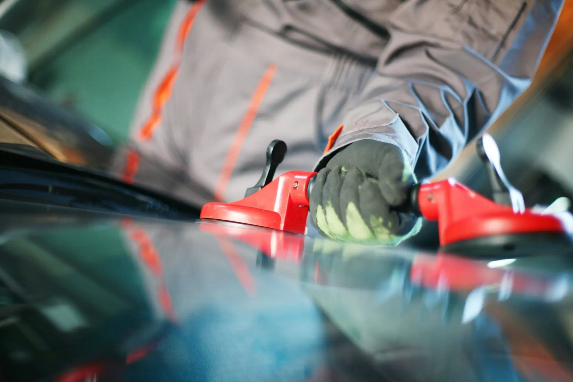 Person using a suction cup on a car dashboard.